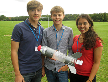 Course participants, from left to right, Matt Harvey (Newcastle-Under-Lyne School), James Tunsley (Perse School) and Alexandra Marland (Tormead Senior School) show off the rocket they created as part of the programme.