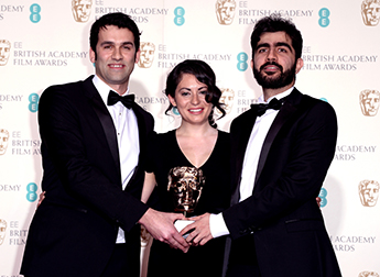 James Walker, Sarah Woolner and Yousif Al-Khalifa with their BAFTA. Photo by: Ray Tang/REX
