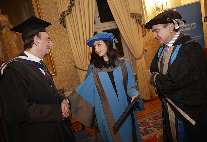 Hadia Tajik receiving her honorary degree from Professor Philip Spencer (L) and Professor Julius Weinberg, Kingston University Vice-Chancellor, in Oslo.