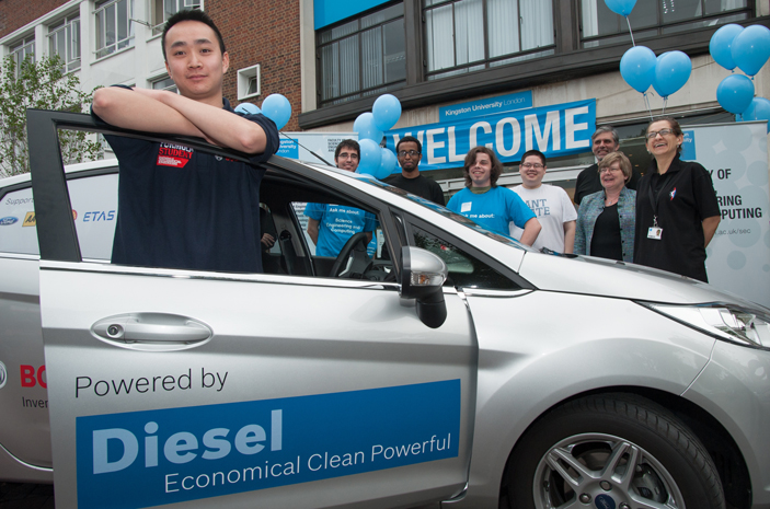 A team of staff and students cheered driver Andy Ng on his way he set off from  Kingston University's Penrhyn Road campus.