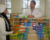Pharmacy student Jamie Wilkinson advises class mate Roohil Yusuf on medication.