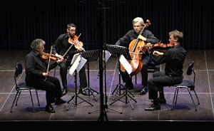 The Arditti quartet performing on stage.