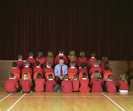 Children from Mayflower Primary School facing away from the camera for a photo with head teacher Steve Springett.