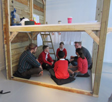 Children planning how to construct their clubhouse with Jim Robertson and Harry Laskowski.