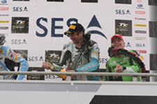 A taste of victory – professional rider George Spence sprays the bubbly. Photo by Dave Kneale, iomtt.com 