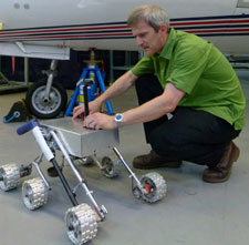 Dr Adam Baker with a Mars rover prototype developed at Kingston University.