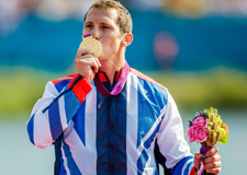 Kingston University graduate Ed McKeever savours his moment on the Olympic podium after kayaking to gold medal glory. Image: A Edmonds/AEphotos.co.uk 