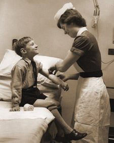 A nurse treating a child at St Gearoge's Hospital, London.