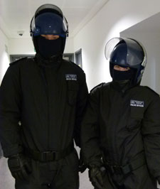 Third-year criminology students try on protective police clothing.
