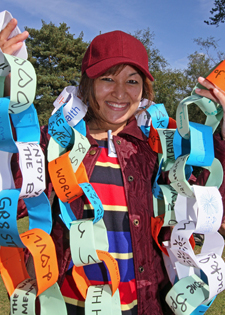 Kingston University nursing student Charitra Gurung holds a paperchain made by people at the event.